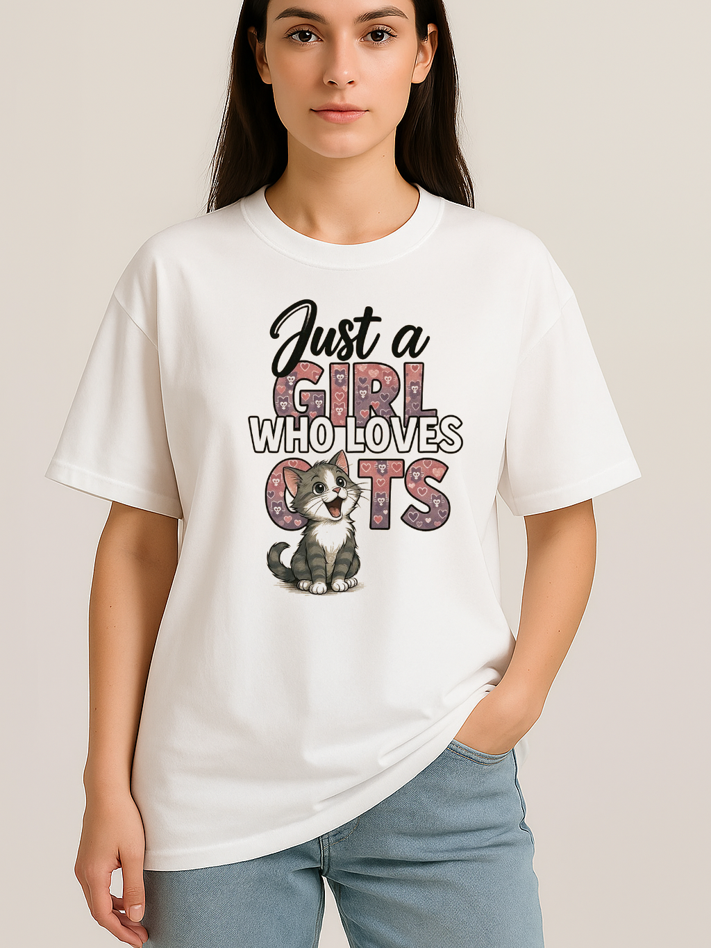 White oversized t-shirt with "Just a Girl Who Loves Cats" text and cute kitten graphic, worn by woman.